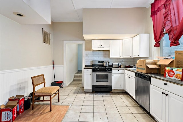 kitchen featuring white cabinetry, appliances with stainless steel finishes, decorative backsplash, and light tile patterned floors