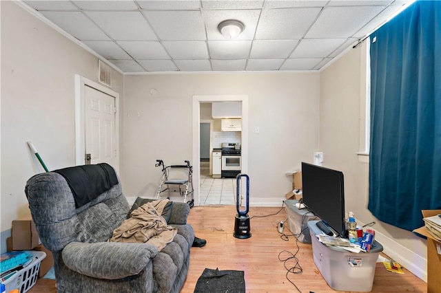 home office featuring hardwood / wood-style floors and a paneled ceiling