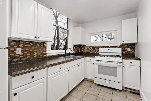 kitchen featuring white cabinetry, sink, and white appliances