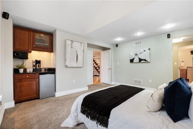 carpeted bedroom featuring fridge and lofted ceiling