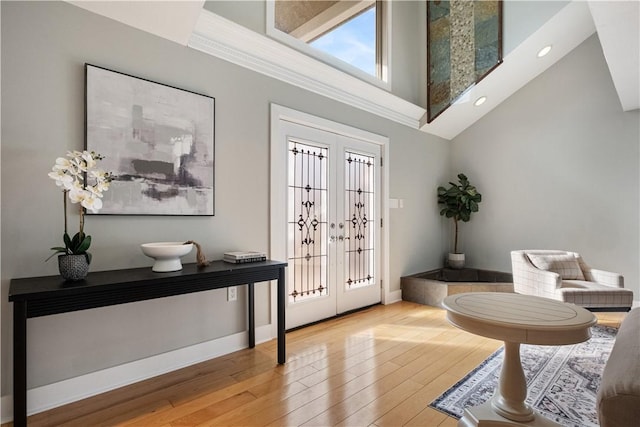 entryway with a high ceiling and light wood-type flooring