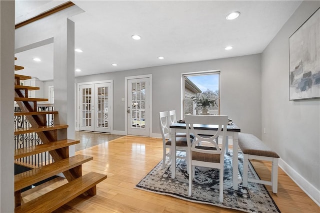 dining room with french doors and light hardwood / wood-style floors