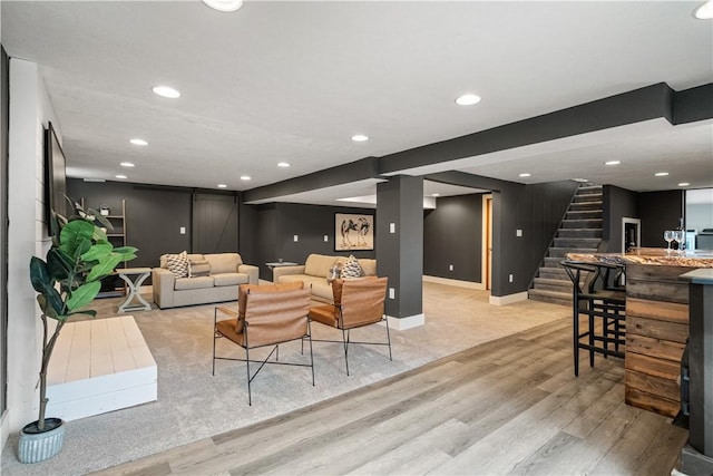 living room featuring bar and light hardwood / wood-style flooring