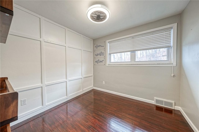 unfurnished room with dark hardwood / wood-style floors