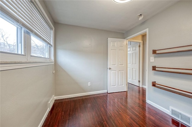 spare room with dark hardwood / wood-style flooring