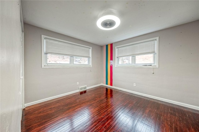 spare room featuring dark hardwood / wood-style flooring