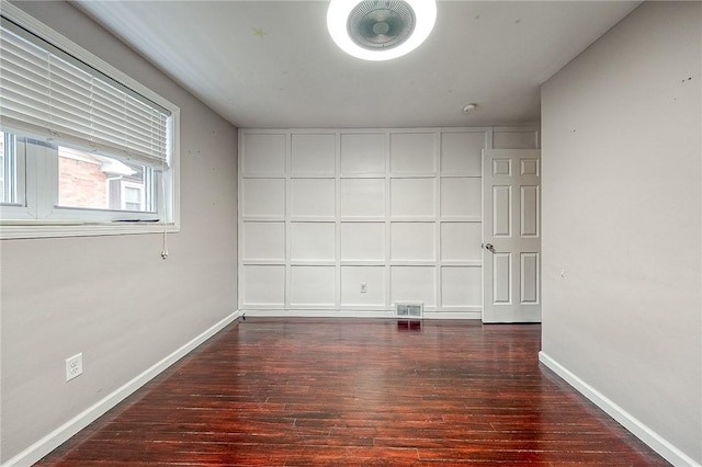 spare room featuring dark wood-type flooring