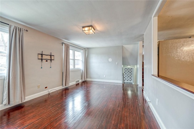 spare room with dark wood-type flooring