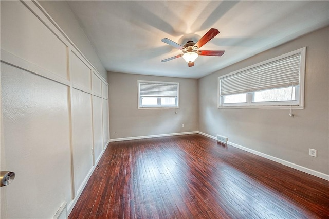 unfurnished bedroom featuring dark hardwood / wood-style floors, ceiling fan, and a closet