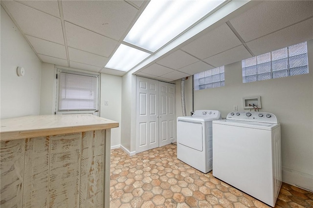 clothes washing area featuring washer and clothes dryer