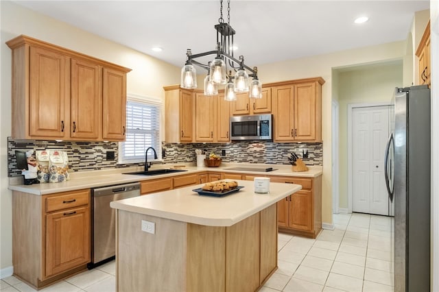 kitchen featuring sink, tasteful backsplash, decorative light fixtures, appliances with stainless steel finishes, and a kitchen island