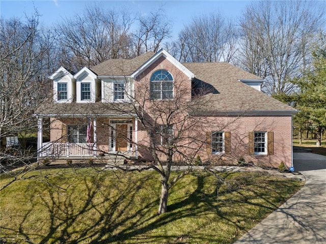 view of front of house with a porch and a front lawn