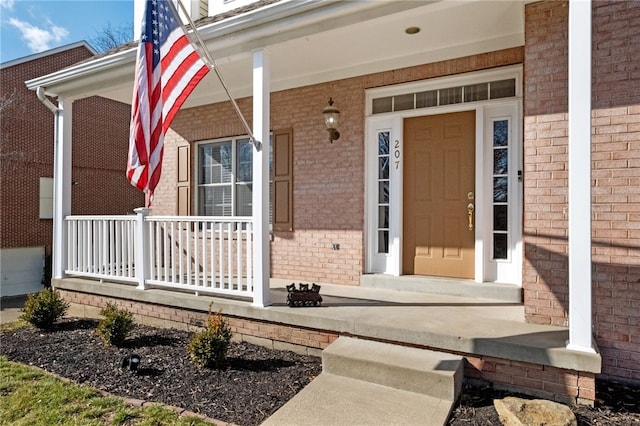 view of exterior entry featuring a porch