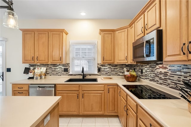 kitchen with sink, hanging light fixtures, stainless steel appliances, light tile patterned flooring, and decorative backsplash