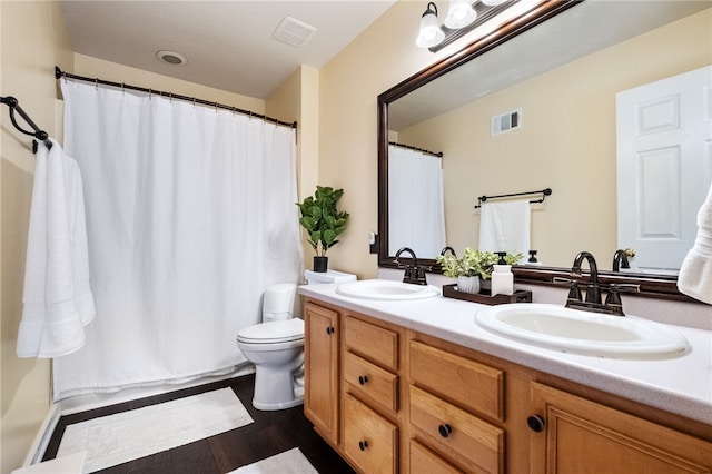 bathroom featuring vanity, hardwood / wood-style floors, and toilet