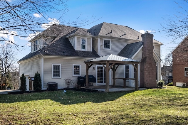 back of house featuring a gazebo, central AC unit, a patio area, and a lawn