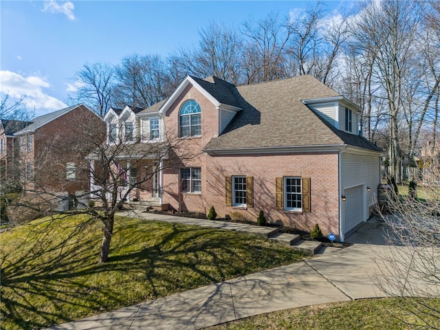 view of front of property with a garage and a front lawn