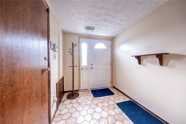 entryway with a textured ceiling