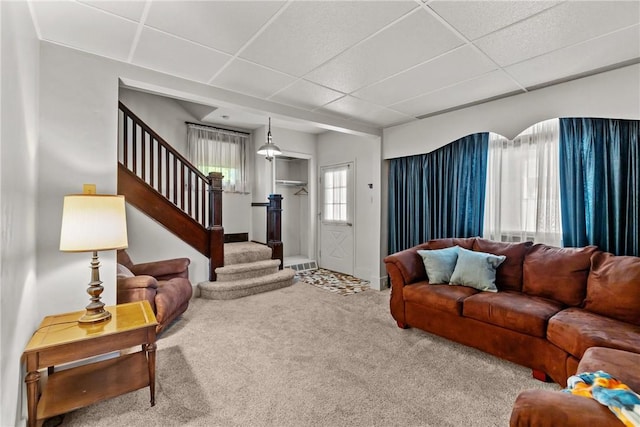 living room with carpet and a drop ceiling