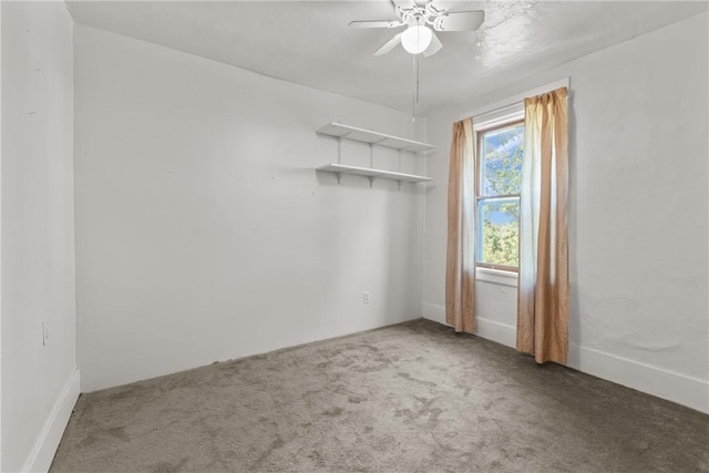 empty room with ceiling fan and carpet flooring