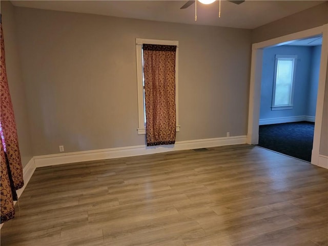 empty room featuring light hardwood / wood-style flooring and ceiling fan