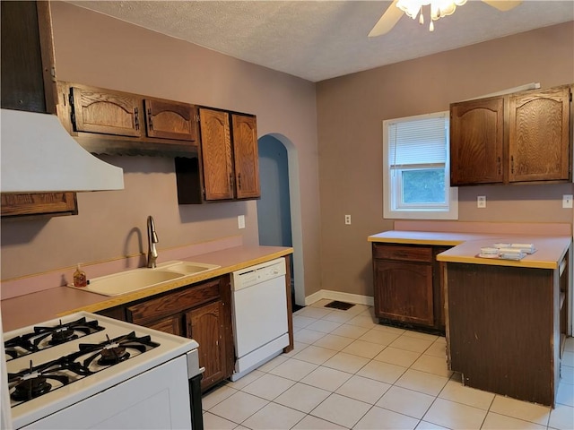 kitchen with sink, white appliances, a textured ceiling, light tile patterned floors, and ceiling fan