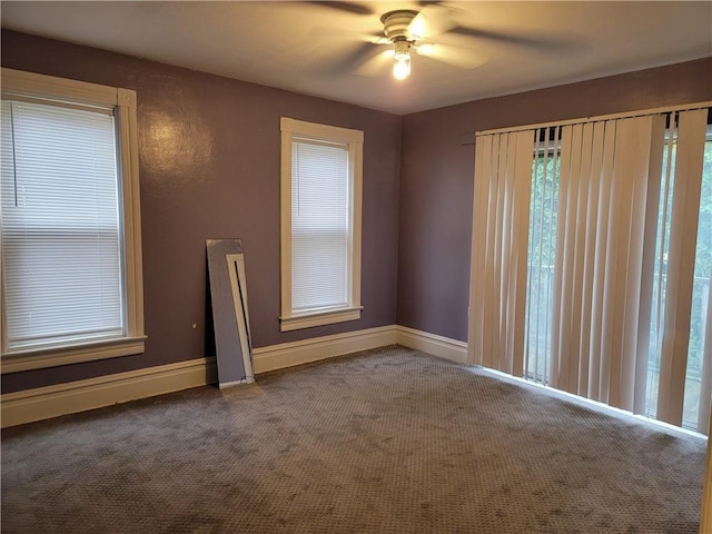 carpeted empty room featuring ceiling fan