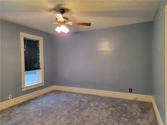 carpeted empty room with ceiling fan and a textured ceiling