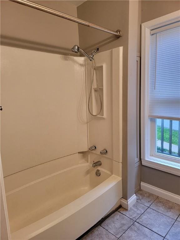 bathroom featuring washtub / shower combination and tile patterned floors