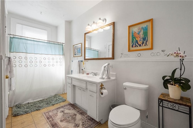 bathroom with vanity, curtained shower, tile patterned floors, and toilet