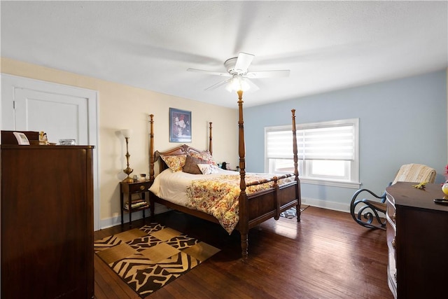 bedroom with dark hardwood / wood-style floors and ceiling fan