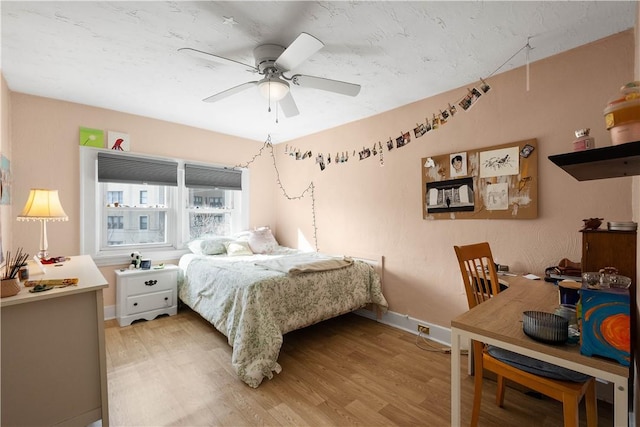 bedroom with ceiling fan and light wood-type flooring