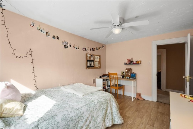 bedroom with ceiling fan and light wood-type flooring