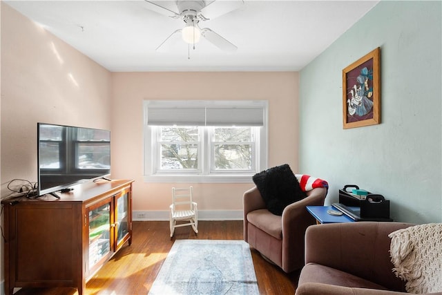 living room featuring hardwood / wood-style floors and ceiling fan