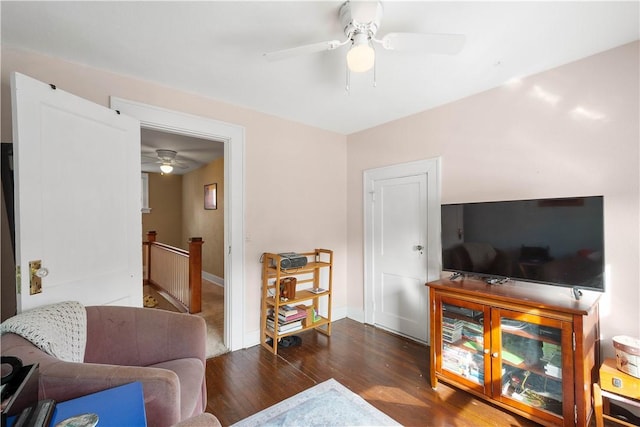 living room featuring dark hardwood / wood-style floors and ceiling fan