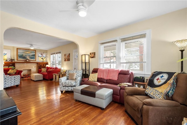 living room with wood-type flooring and ceiling fan