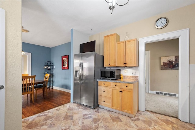 kitchen featuring light brown cabinetry and stainless steel fridge with ice dispenser