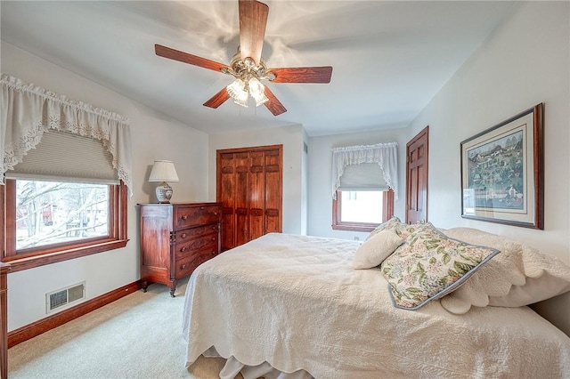 bedroom with light carpet and ceiling fan