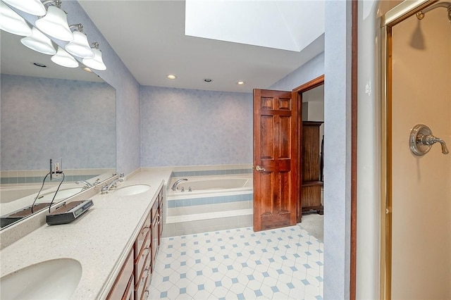 bathroom featuring a relaxing tiled tub and vanity