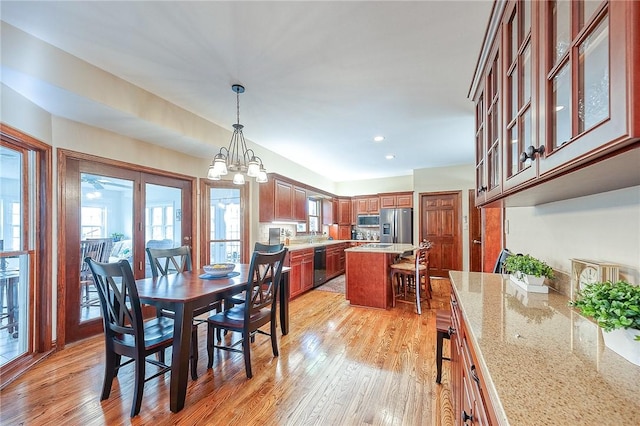 dining area with a chandelier and light wood-type flooring