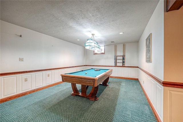 rec room with pool table, carpet floors, and a textured ceiling