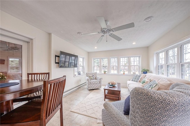 living room with ceiling fan, a baseboard radiator, plenty of natural light, and a textured ceiling