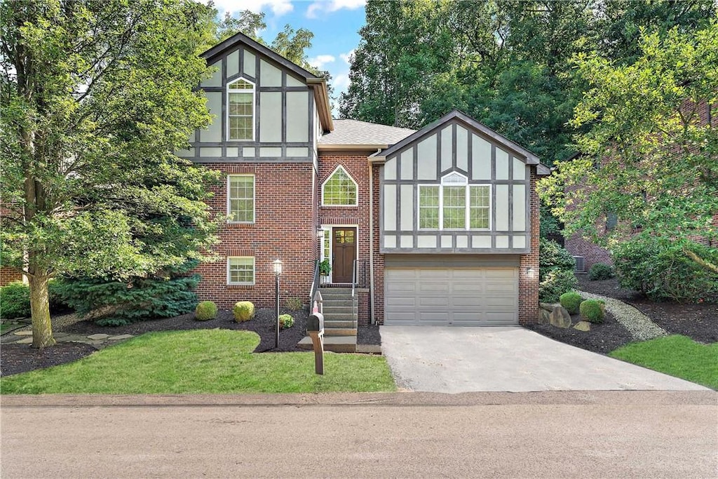 english style home featuring a garage