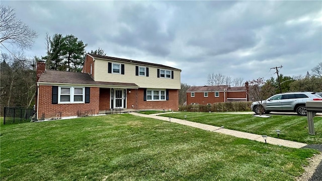 view of property featuring a front lawn