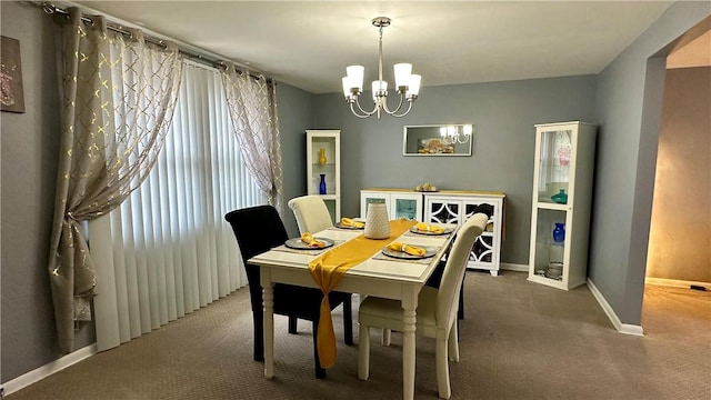 carpeted dining space featuring a notable chandelier