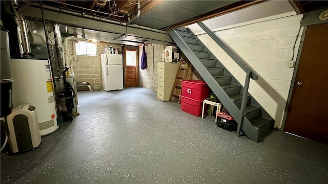 basement featuring white refrigerator and gas water heater