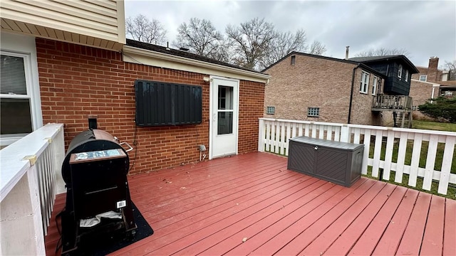 wooden terrace featuring a grill