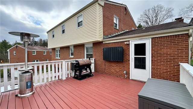 wooden deck featuring area for grilling