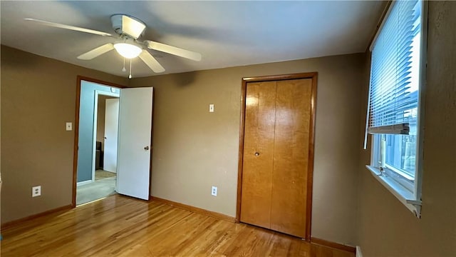 unfurnished bedroom featuring light hardwood / wood-style floors, a closet, and ceiling fan