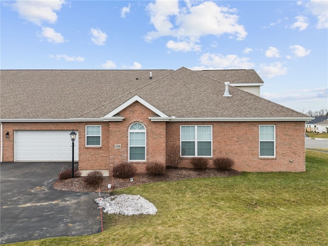 view of front of house with a garage and a front yard